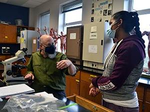 Student and a faculty member working in an anatomy lab.