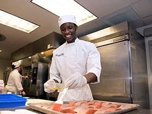 Culinary arts student working in the culinary lab.